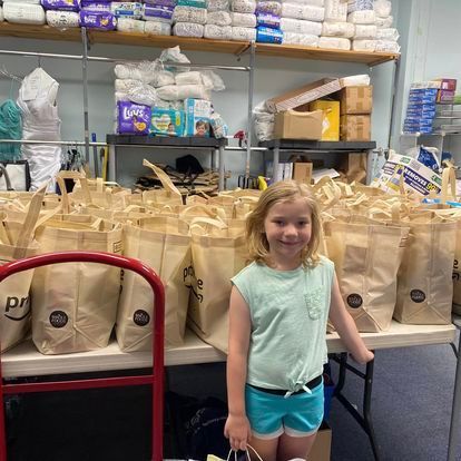 little girl with food bags