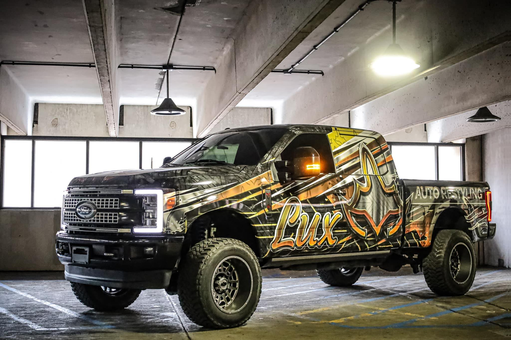 A black truck is parked in a parking garage.