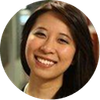 A close up of a woman 's face in a circle smiling.