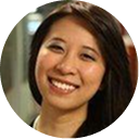 A close up of a woman 's face in a circle smiling.