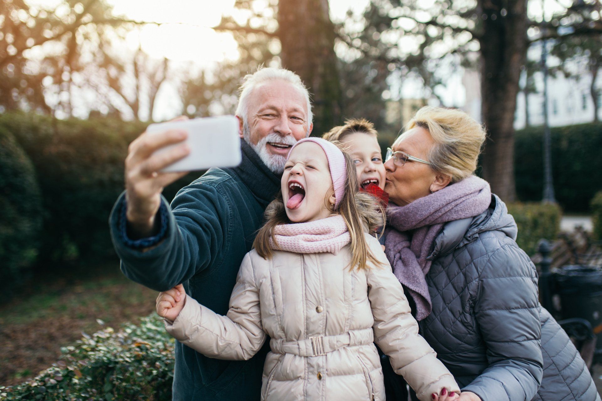 a family taking a selfie with a little girl sticking her tongue out