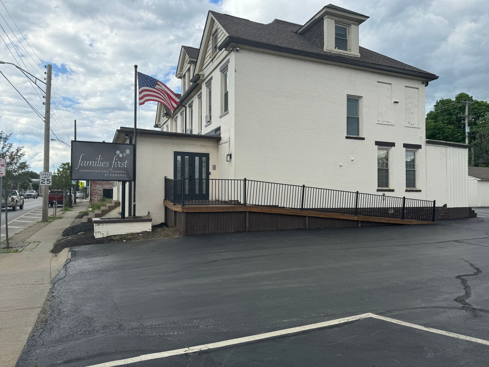 A large white building with an american flag in front of it