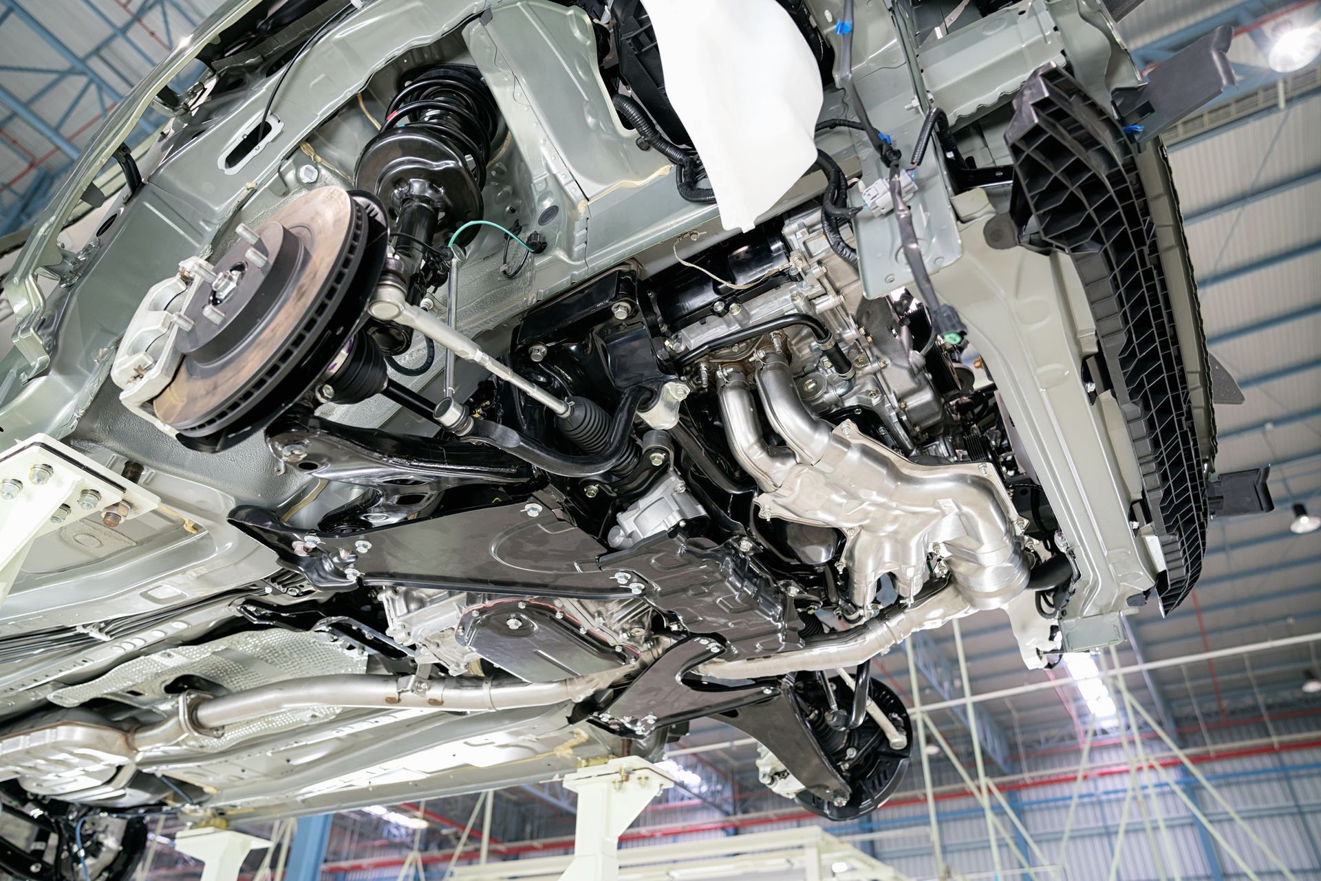 The underside of a car is being built in a factory - Poway, CA - Freddie’s Domestic Import and Auto Service