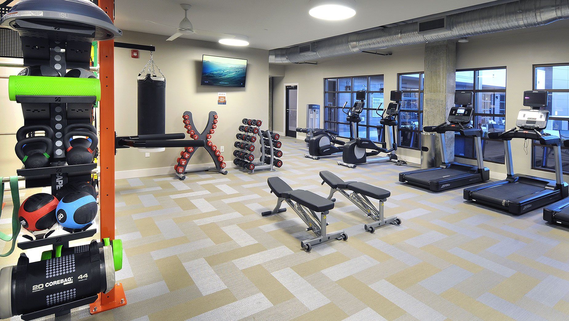 Spacious Fitness Center with Treadmill and Weights at North and Line