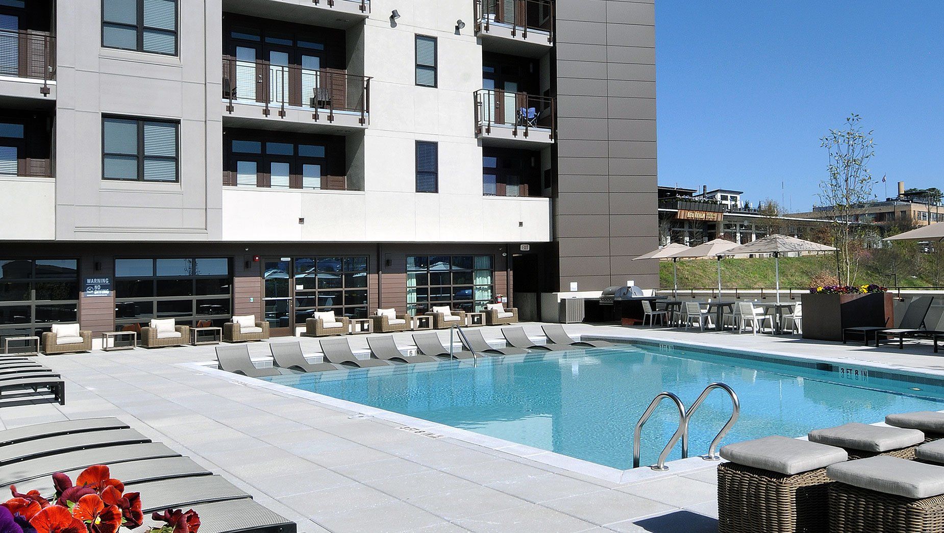 Poolside View with Apartment Buildings and Walking Trail at North and Line