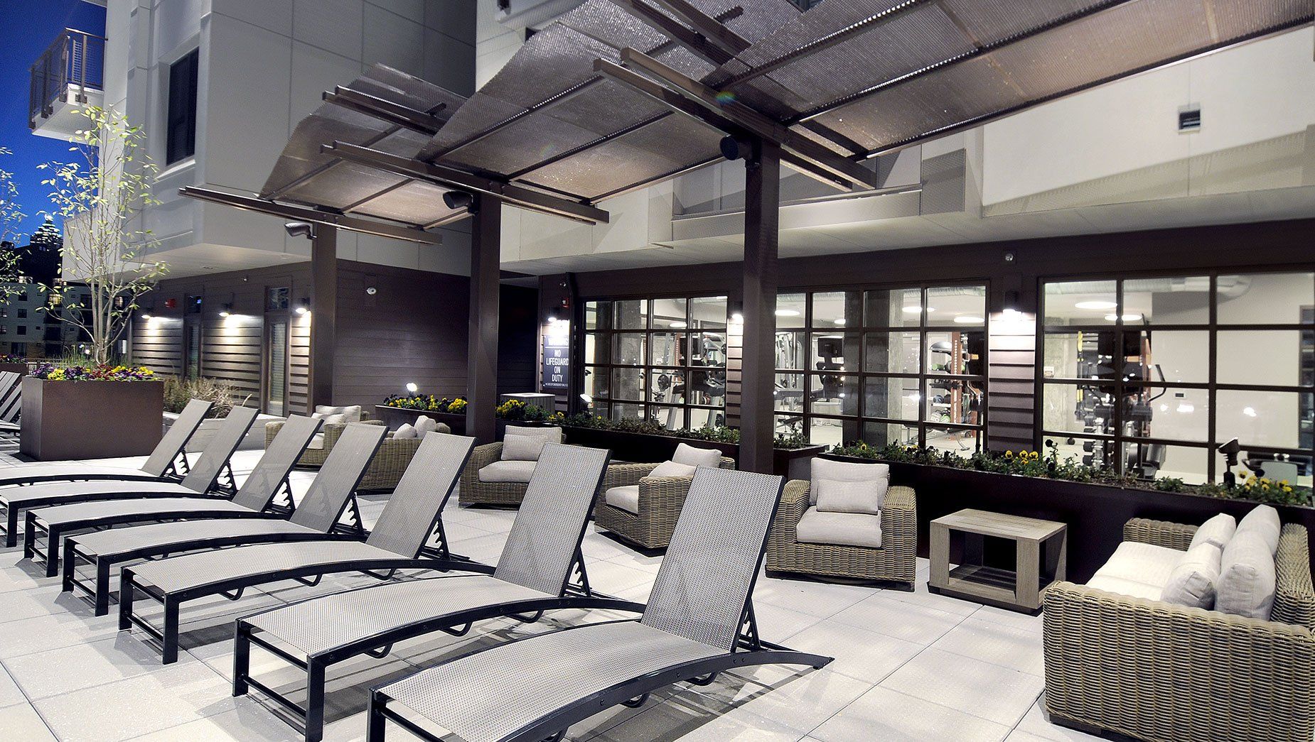 Poolside Lounge with Chaise Lounge Chairs and Sofa at North and Line