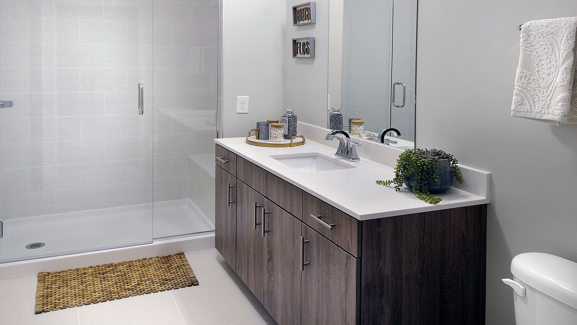 Apartment Resort Style Bathroom with Frameless Shower Enclosures at North and Line