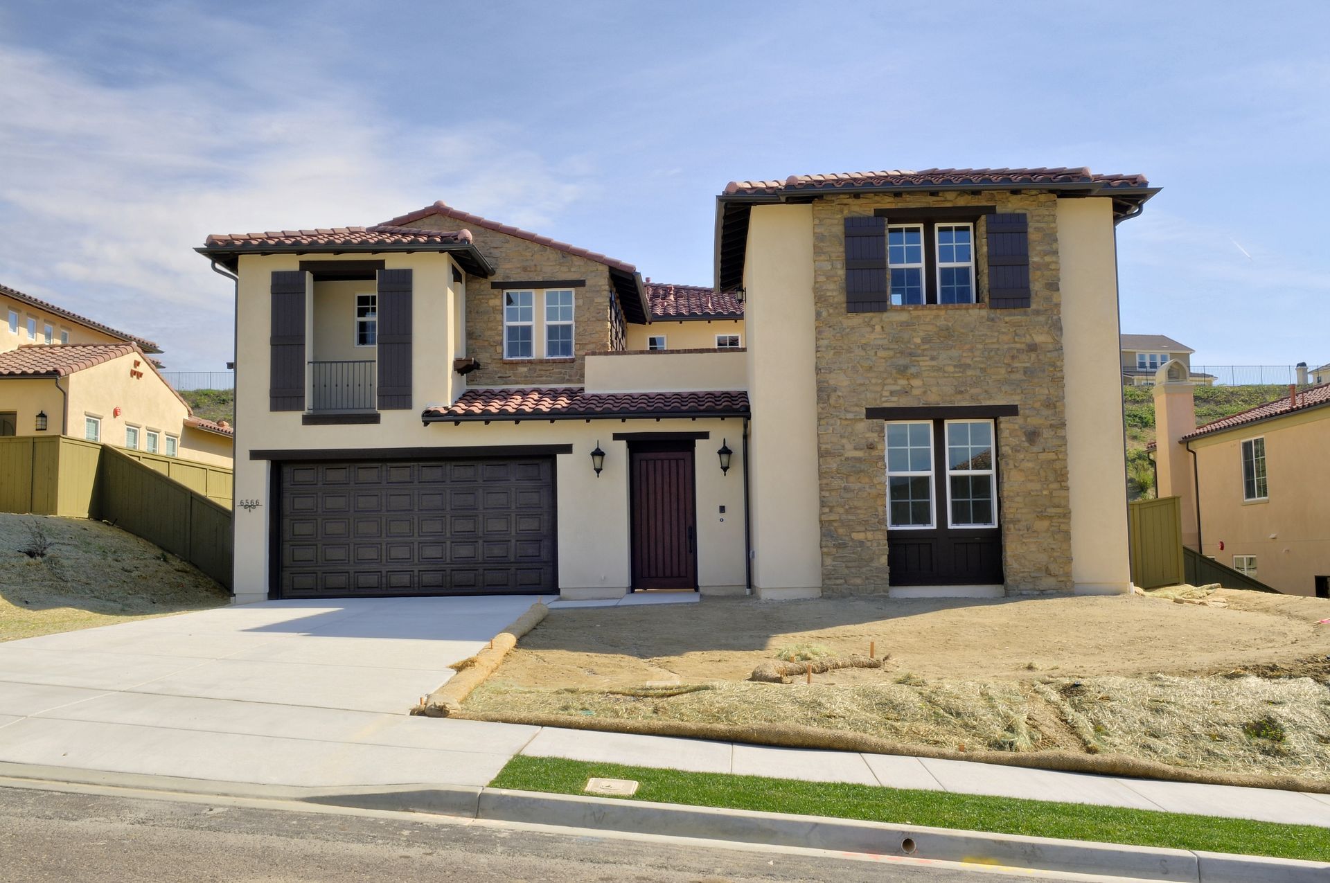 A large house with a garage and shutters on the windows