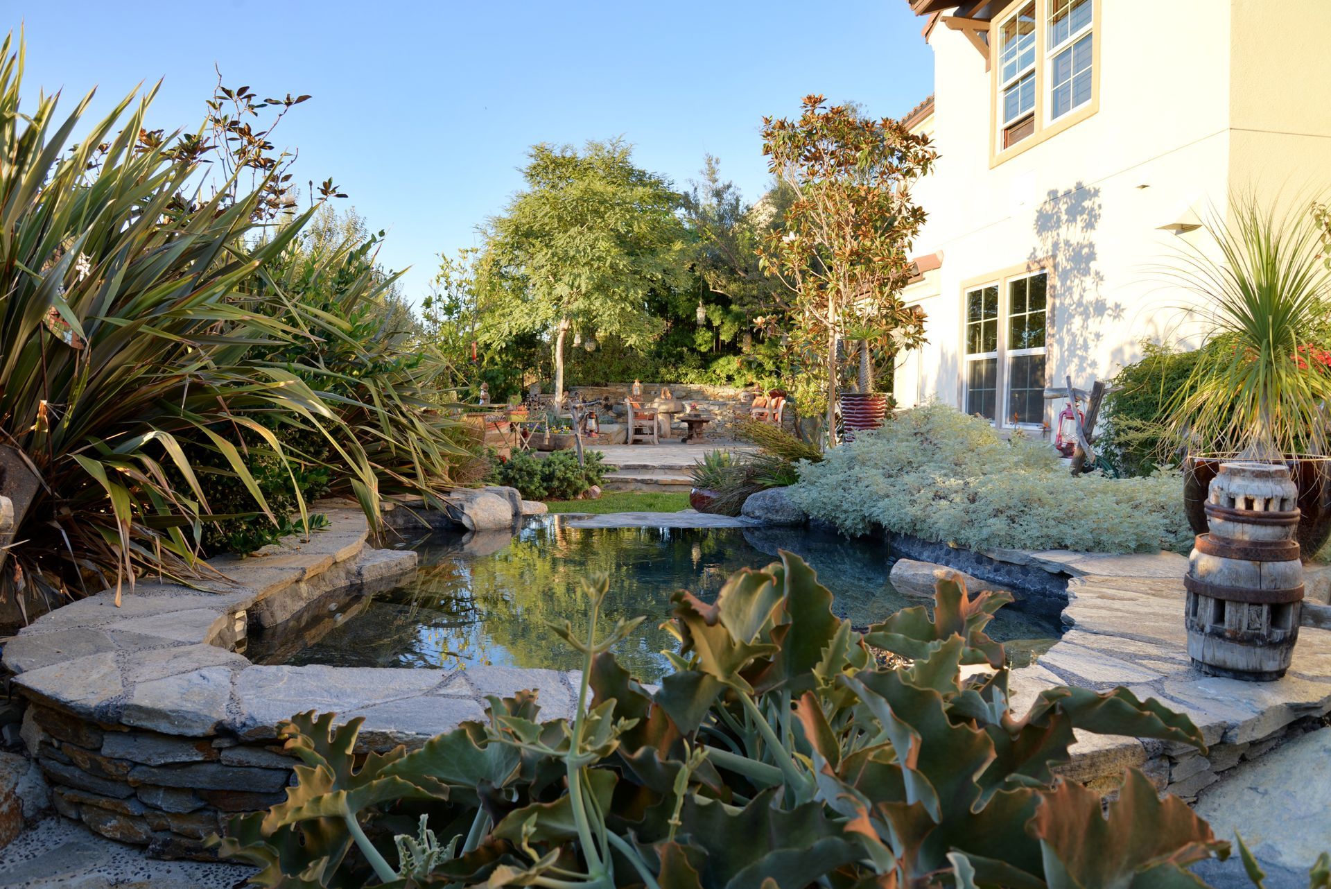 A large house with a pond in front of it