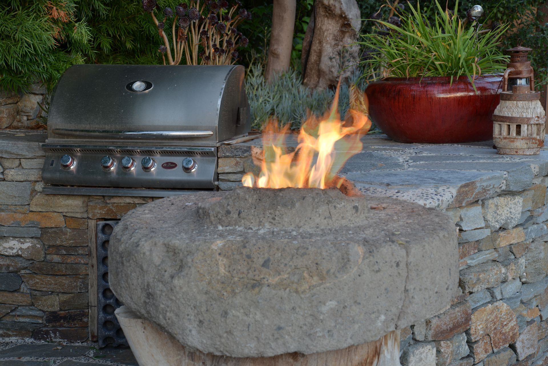 A fire pit with a grill in the background.
