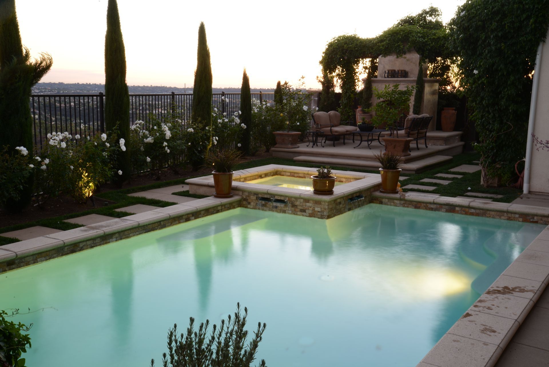 A large swimming pool with a gazebo in the background