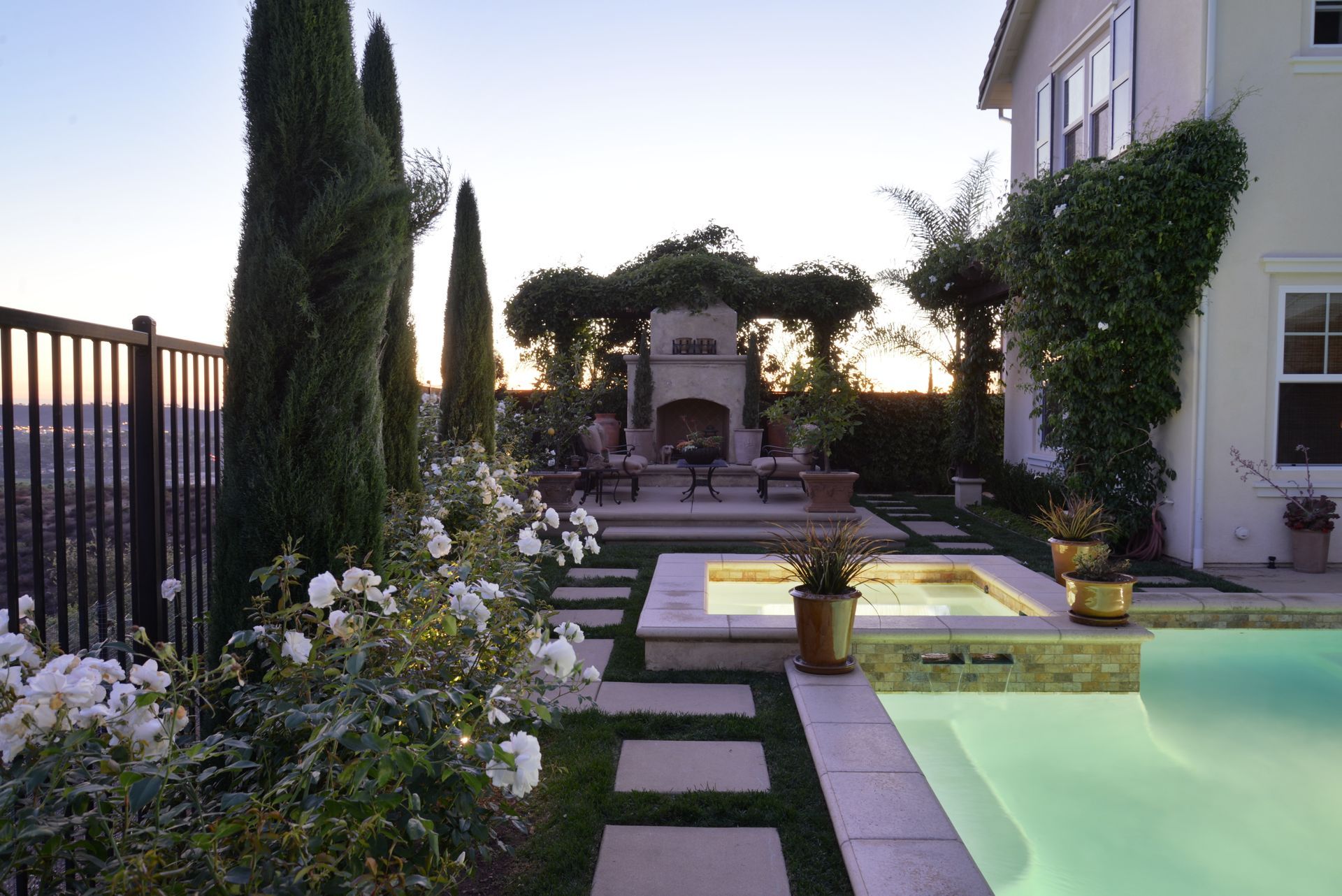 A backyard with a swimming pool and a fireplace