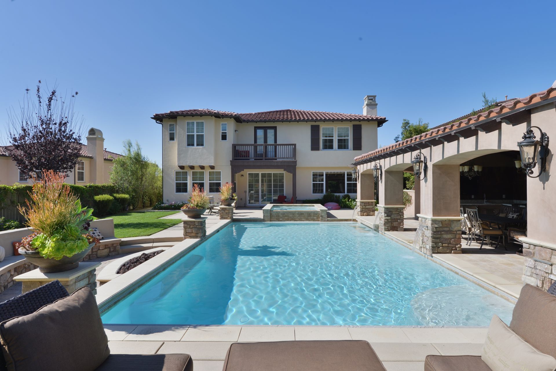 A large house with a large swimming pool in front of it