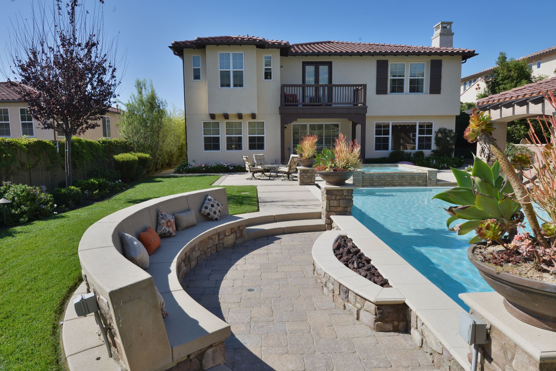 A large house with a large swimming pool in front of it