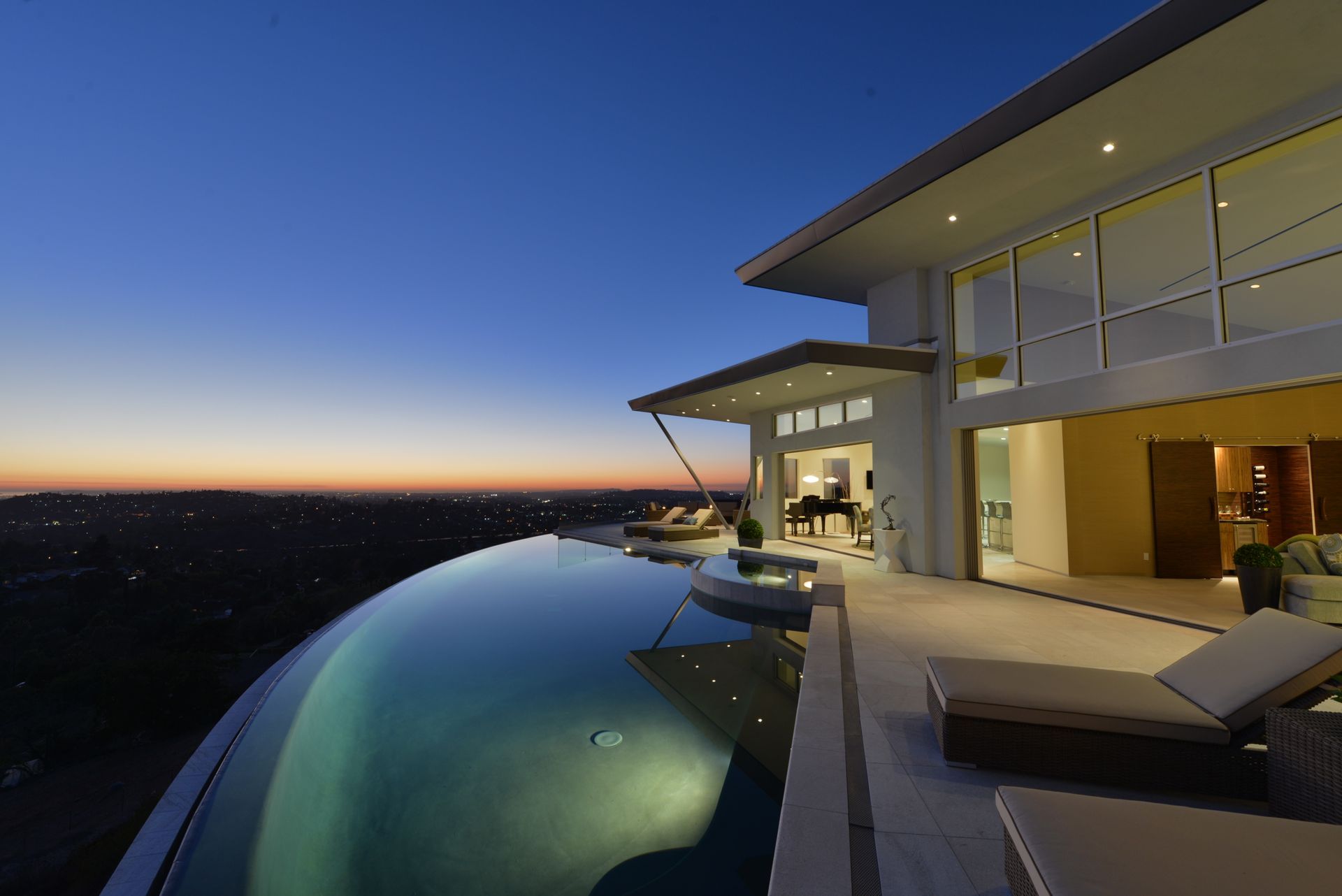 A large house with a swimming pool in front of it