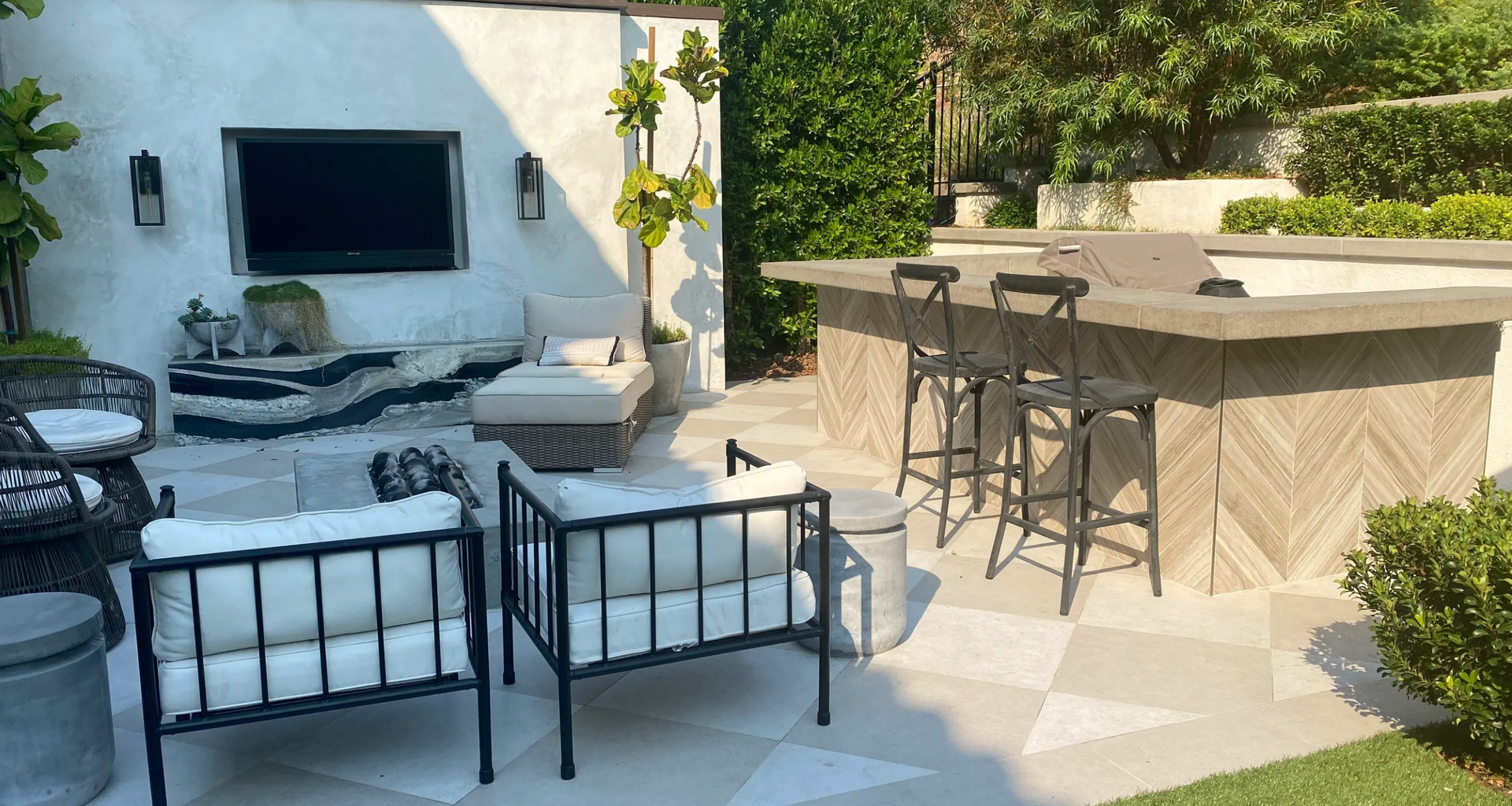A patio with a bar and a television on the wall.