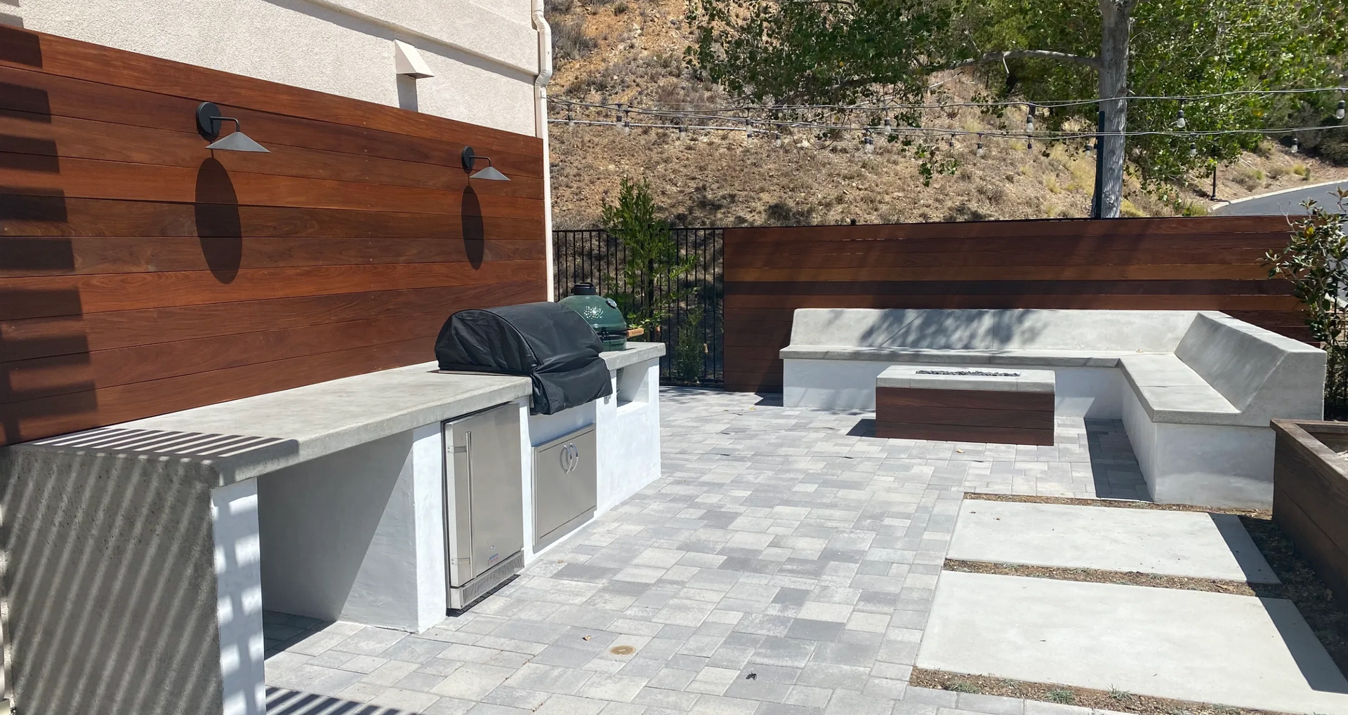 A patio with a grill and a fire pit