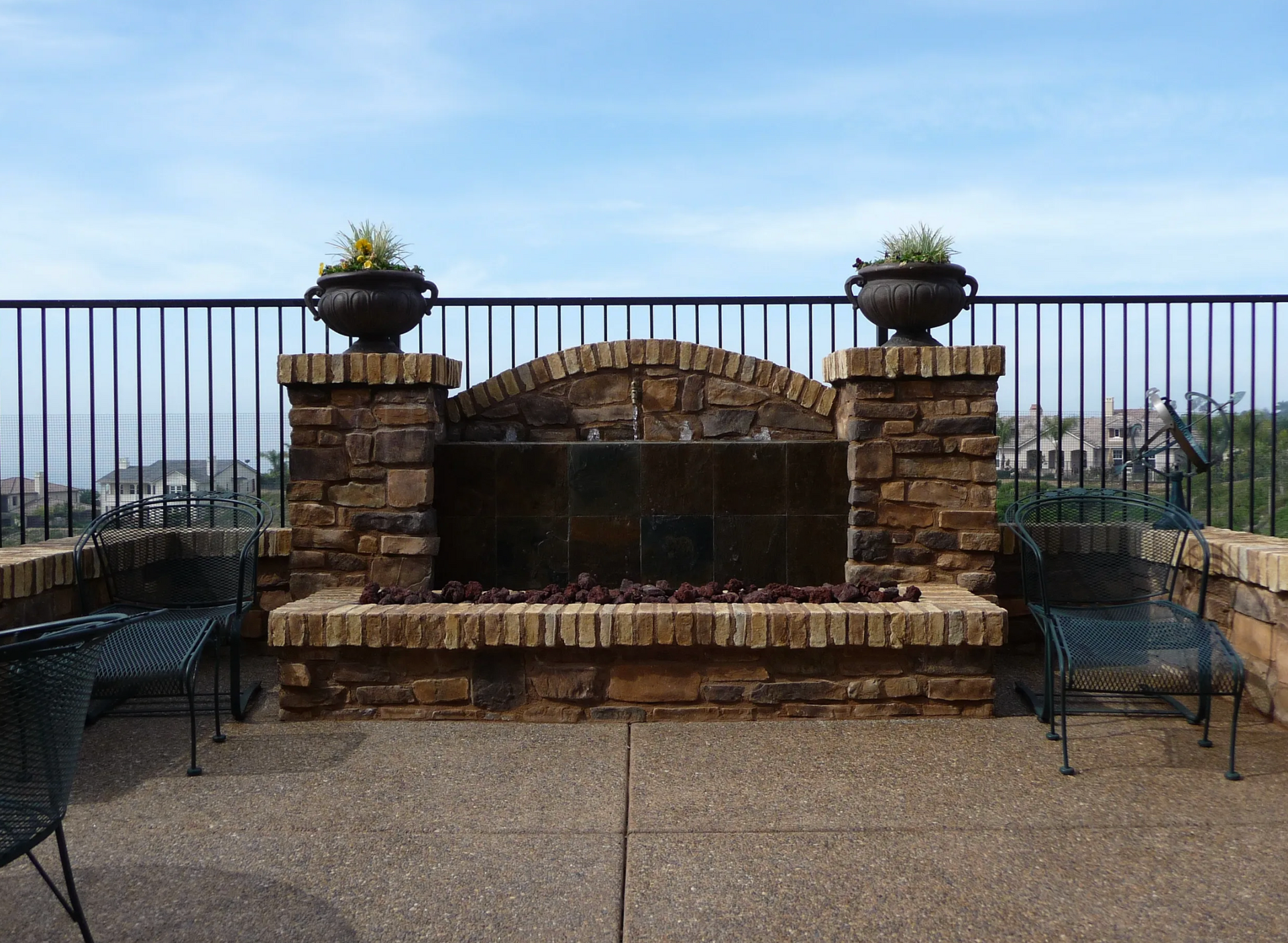 A brick fireplace with a waterfall in the middle of it