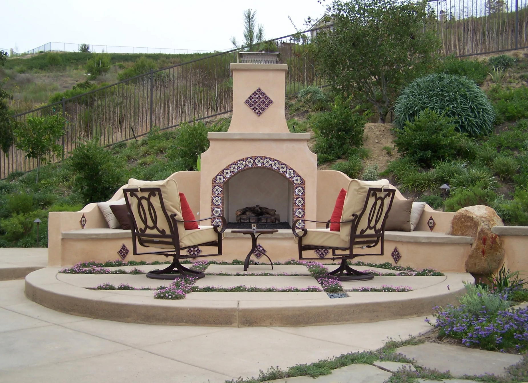 A fireplace with a table and chairs in front of it