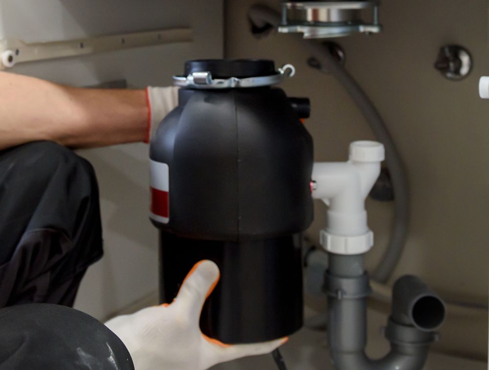 Plumber Repairing a Garbage Disposal