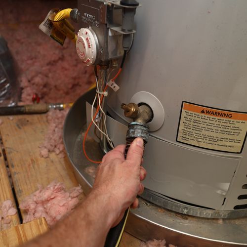 Plumber Fixing a Water Boiler