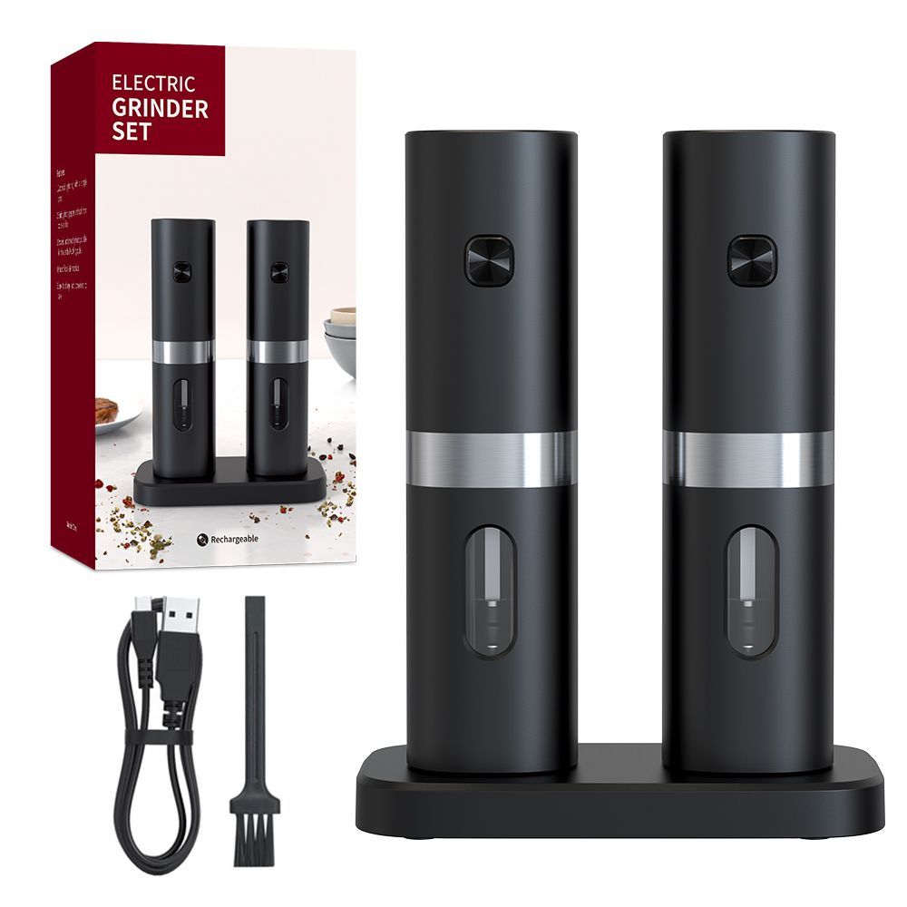 A set of two black electric salt and pepper grinders on a charging base, with a USB cable, cleaning brush, and box.
