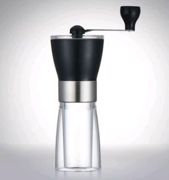 A manual coffee grinder with a black hopper, stainless steel band, and a transparent bottom chamber on a white background.