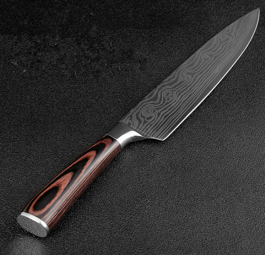 A chef’s knife with a patterned Damascus steel blade and a polished wood-grain handle on a black textured background.