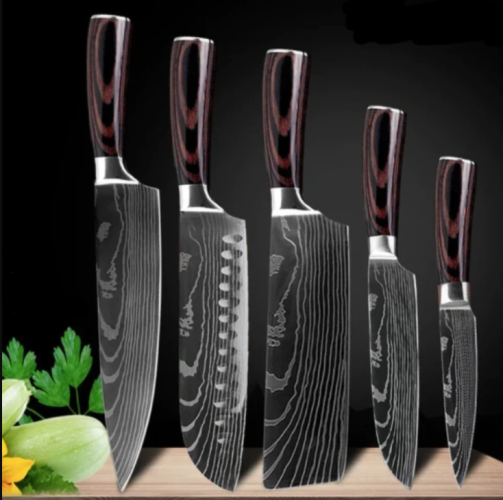 A set of five Damascus-style kitchen knives with dark wood-grain handles standing upright on a wooden surface.