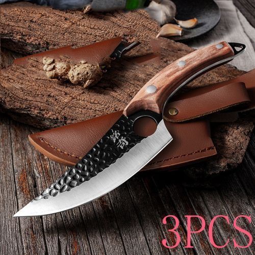A forged steel knife with a hammered blade and wooden handle resting on its leather sheath on a textured wooden surface.