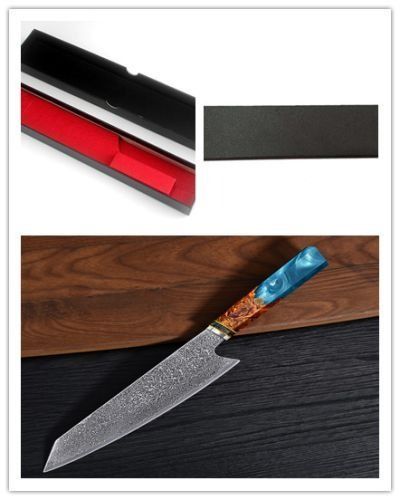 A Damascus steel chef's knife with a blue and wood-grained resin handle displayed next to an open black and red gift box.