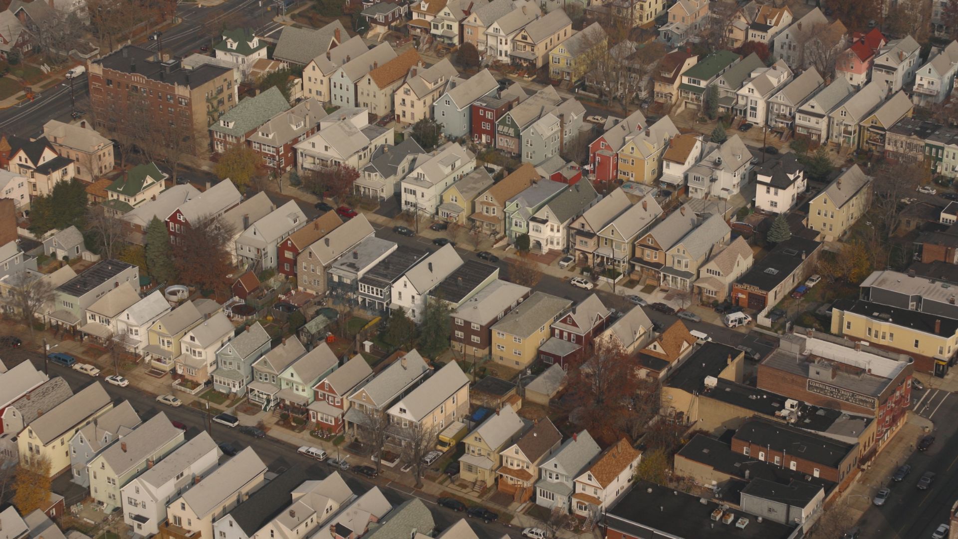 Aerial view of tightly packed rows of houses in a residential neighborhood.