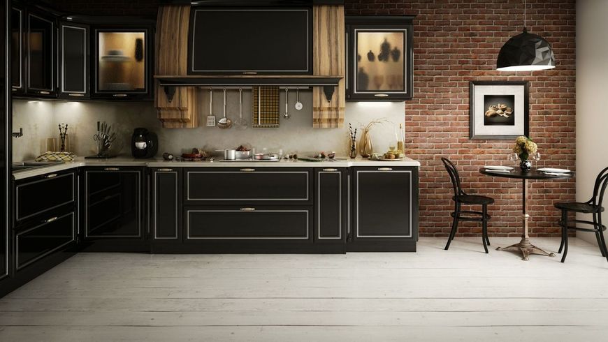 Modern kitchen with black cabinets, brick accent wall, and a small dining nook by a window