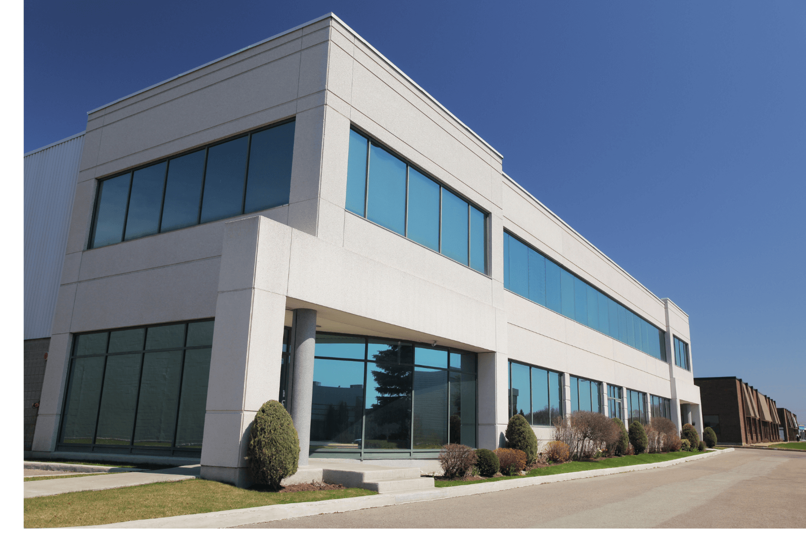 Freshly poured concrete sidewalk, framed by wooden forms, in a construction setting with surrounding dirt.