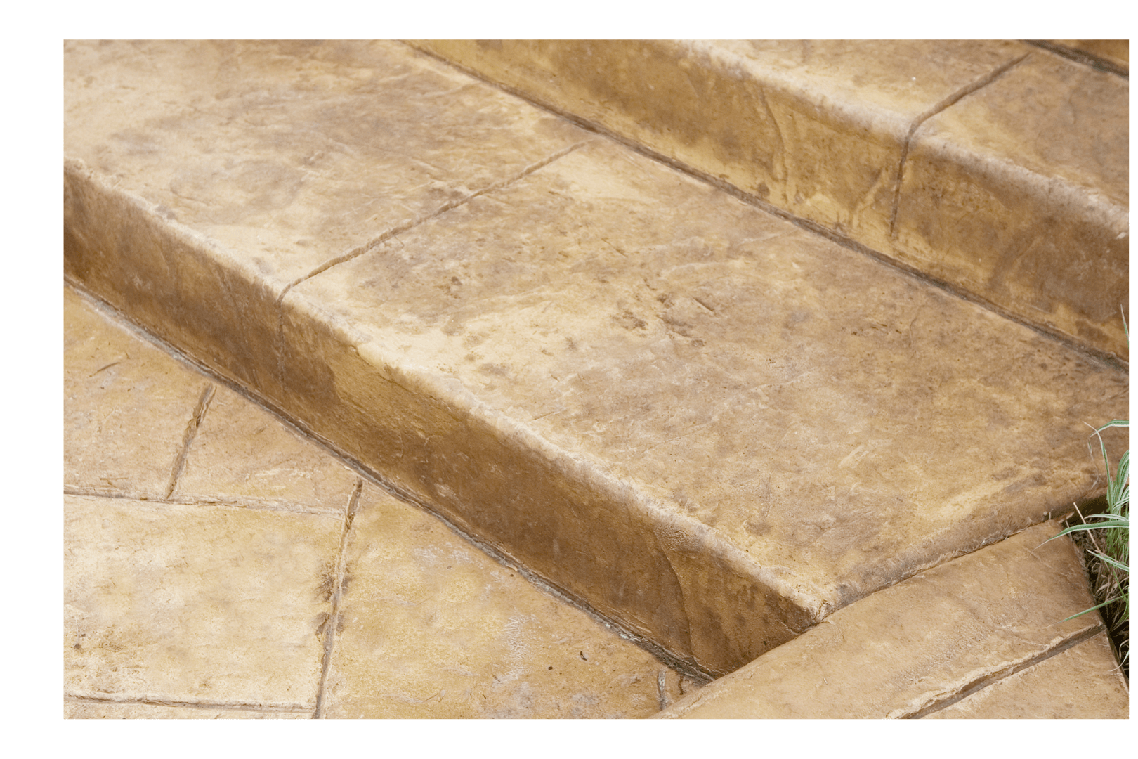 Freshly poured concrete sidewalk, framed by wooden forms, in a construction setting with surrounding dirt.
