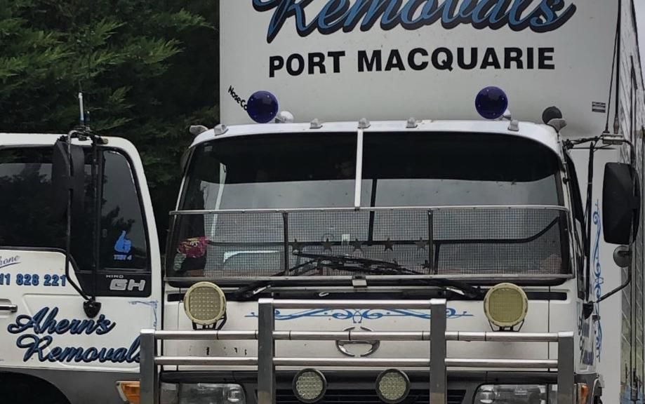 Two Removal Trucks Are Parked Next To Each Other In Port Macquarie — Ahern's Removals In Lake Cathie, NSW