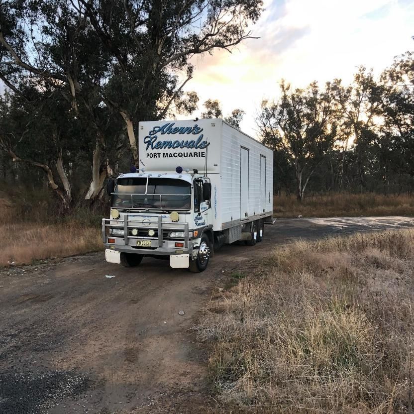 A Moving Truck Is Parked On The Side Of A Dirt Road — Ahern's Removals In Taree, NSW