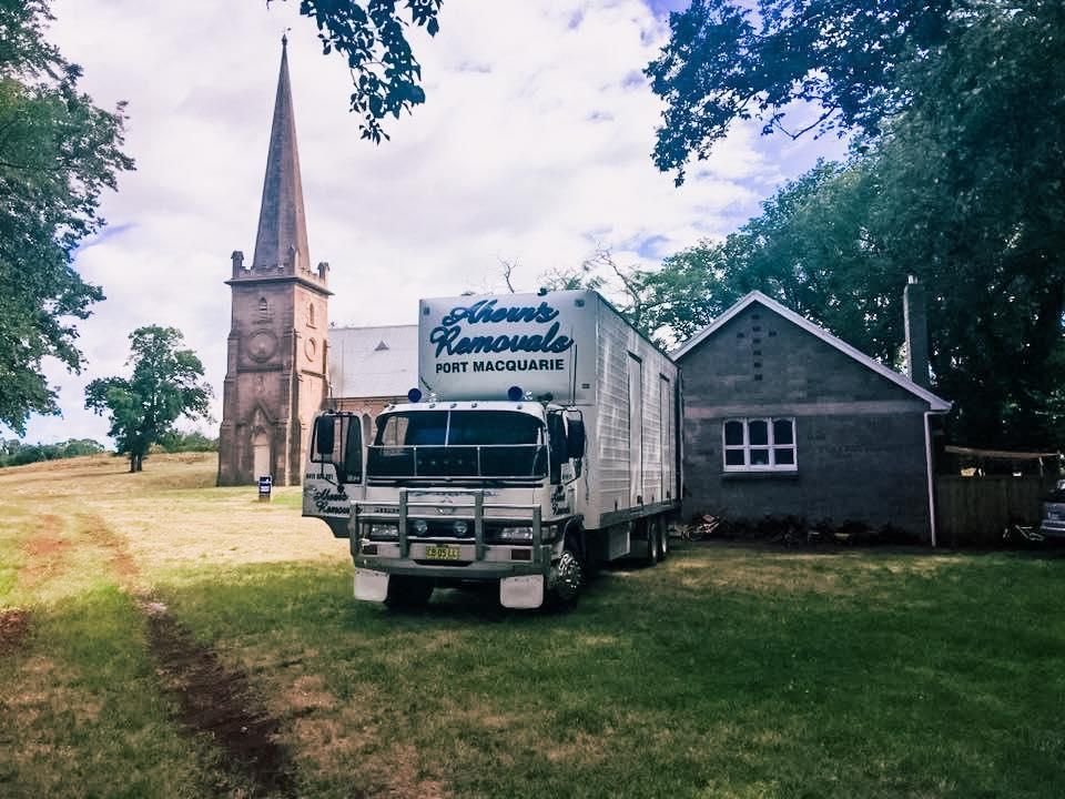 A Phoenix Removals Truck Is Parked In Front Of A Church — Ahern's Removals In Port Macquarie, NSW