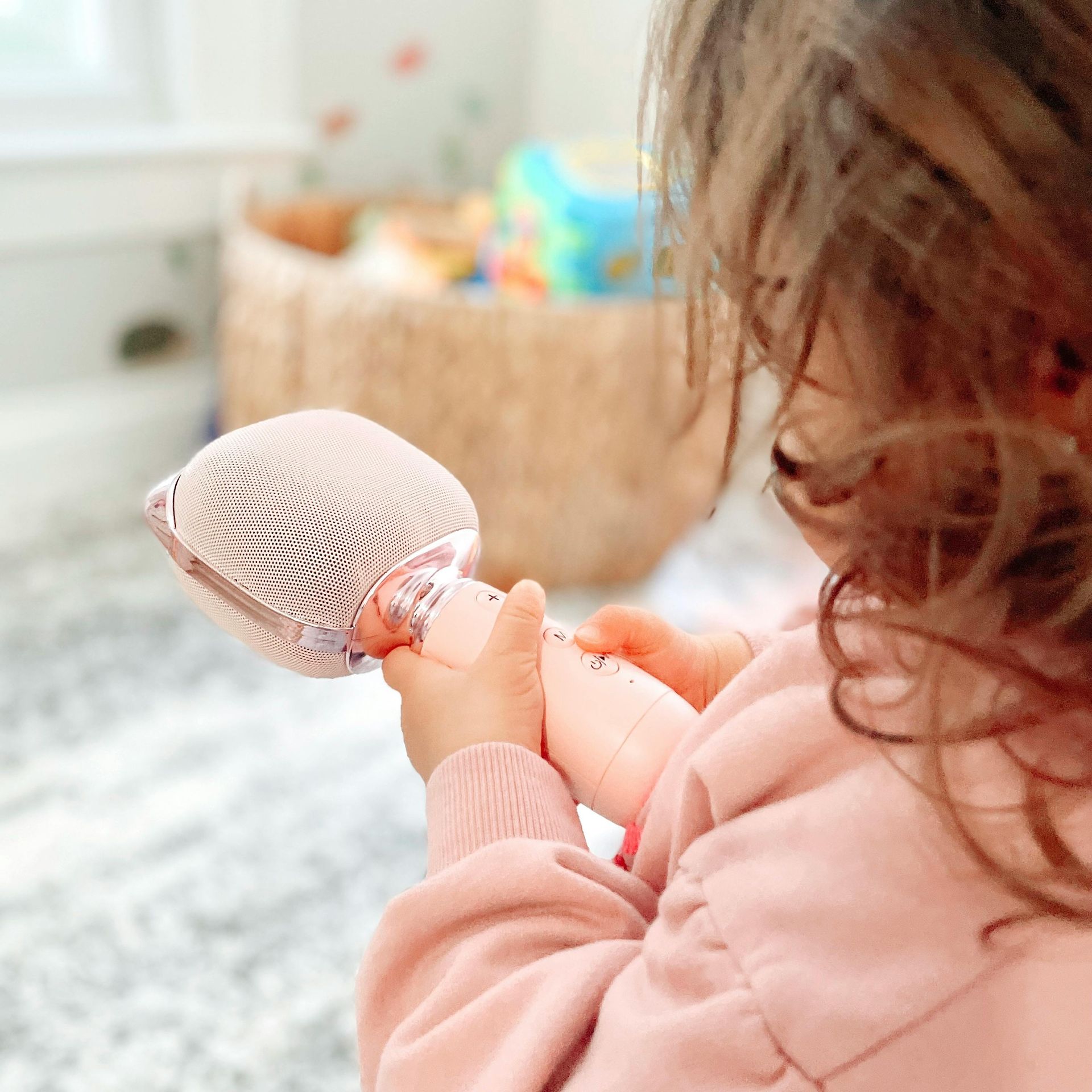 A little girl is holding a doll in her hands.