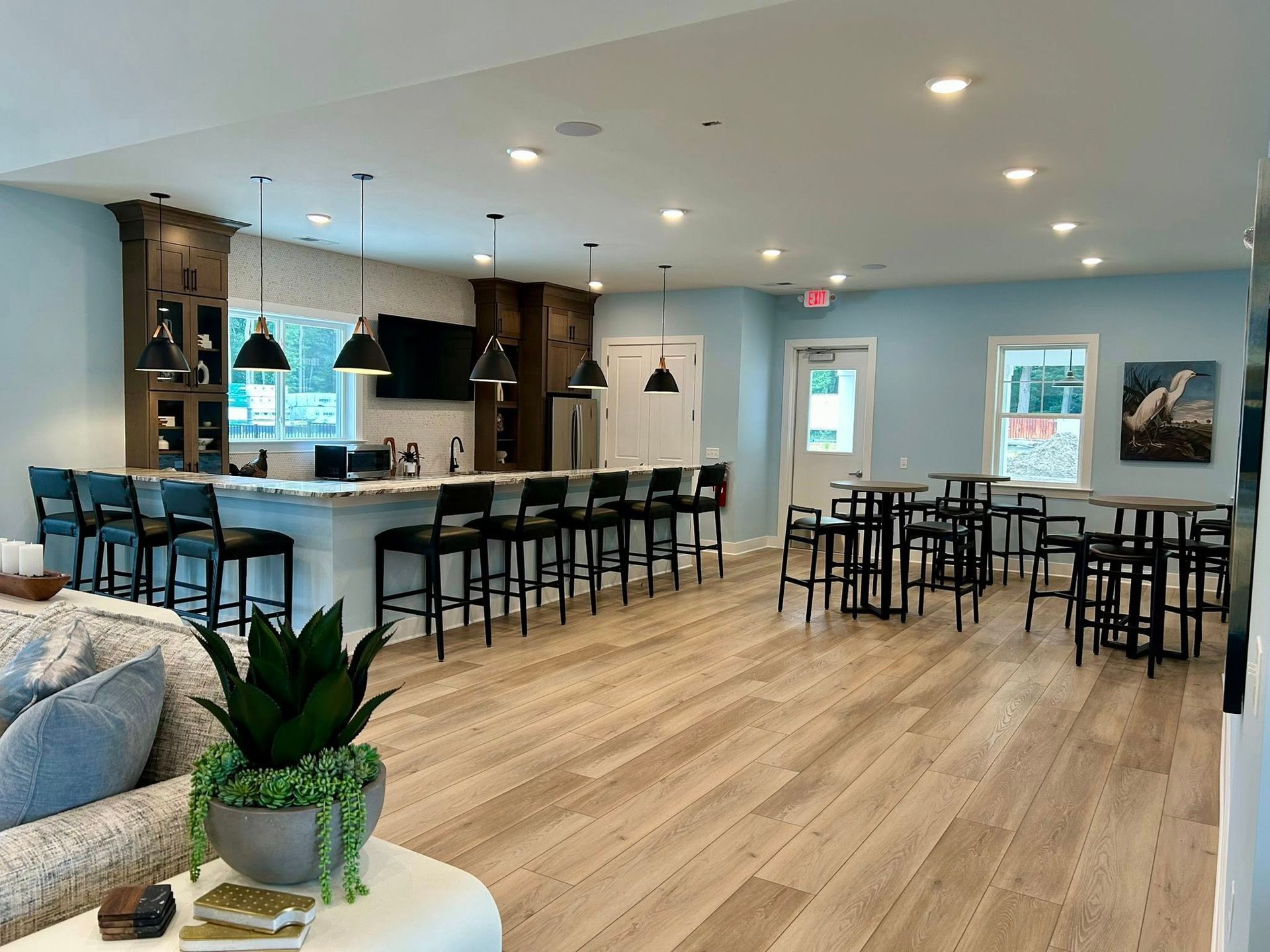 A large room with tables and chairs and a couch.