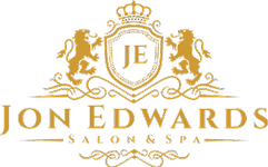 Jon Edwards Salon & Spa logo: gold crest with lions, crown, and initials "JE".