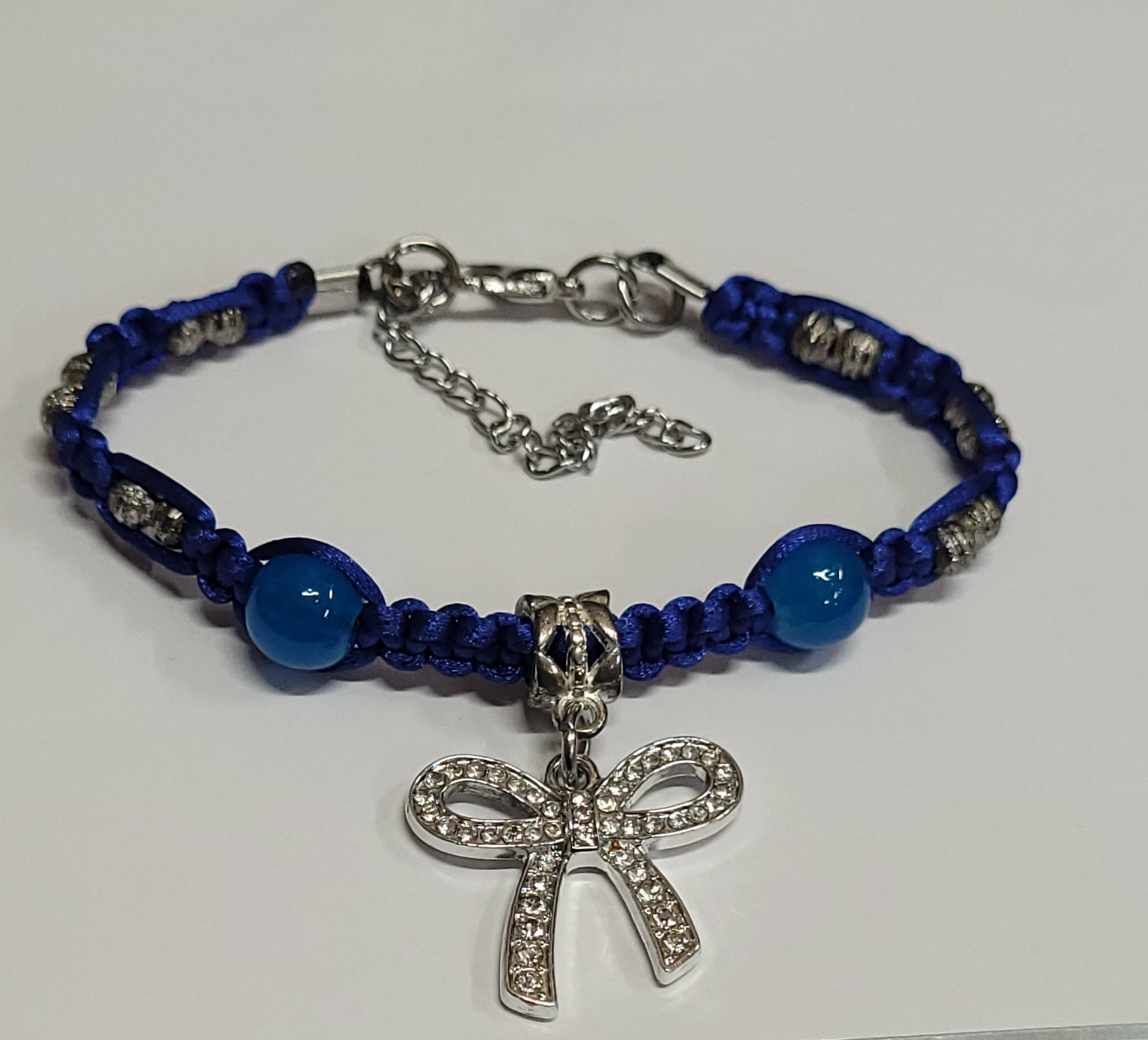 Blue Macrame Bracelet/Anklet featuring a Silver Bow & Glass beads, fits from 6.5 to 10 inches, durable 316 stainless steel accents.