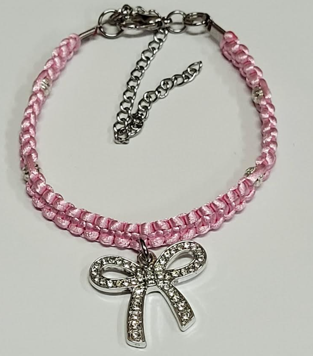 Pink braided pet collar with rhinestone bow charm.