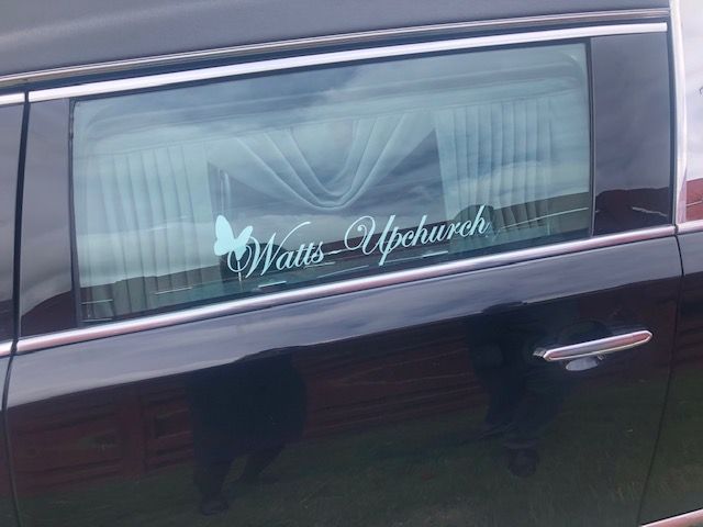 A black car window with a white decal reading 