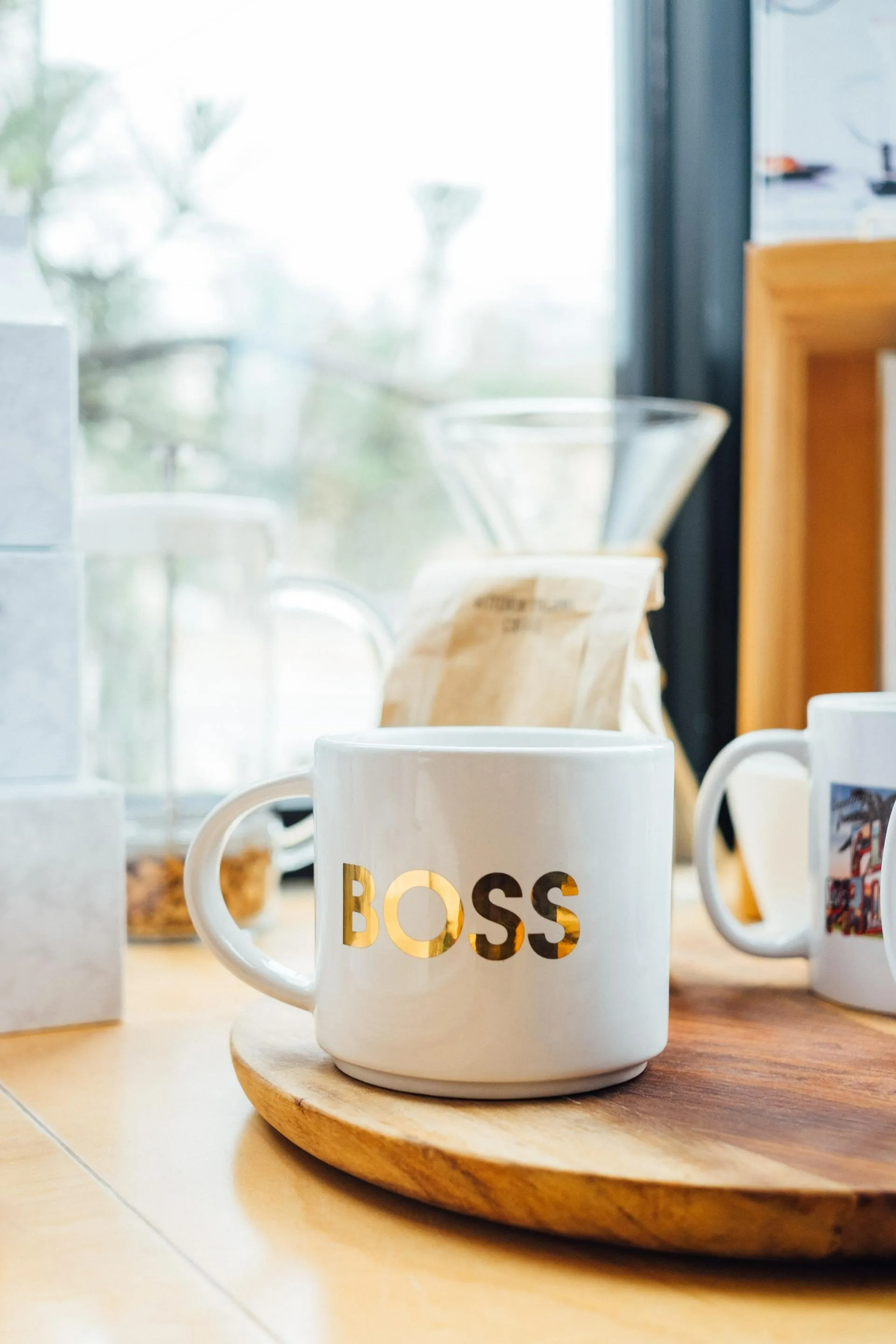 A white coffee mug with the word boss on it