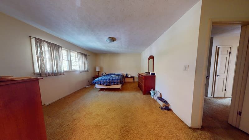 Flooded bedroom with damaged carpet