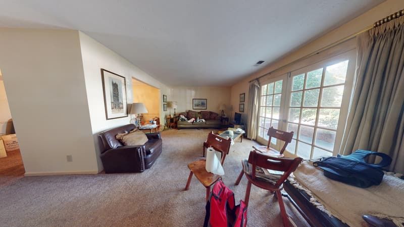 Flooded living room with damaged carpet before restoration