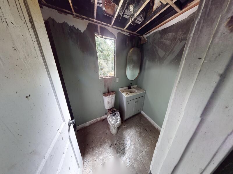 Primary bathroom fire damage before restoration