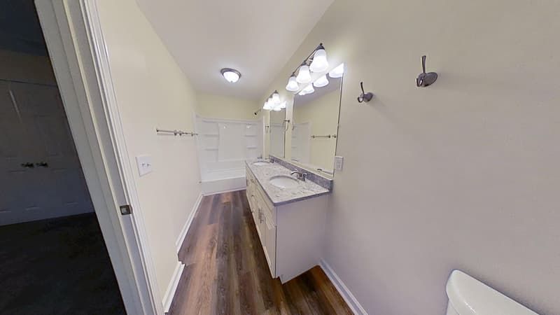 Second bathroom after complete fire damage restoration with refreshed tile clean walls and repaired ceiling