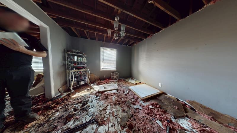 Bedroom before fire damage restoration with burned walls and soot-stained ceiling